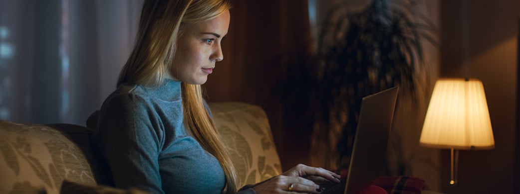 woman working from home on laptop in evening time