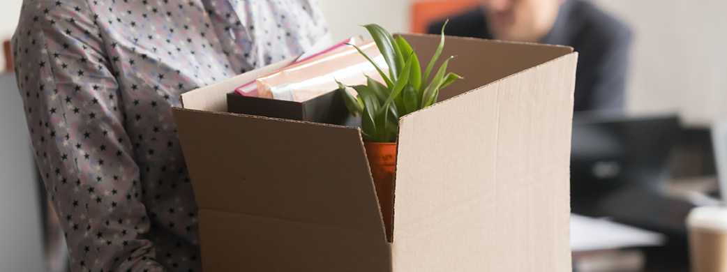 person carrying box of belongings