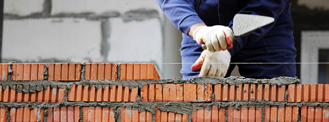 Worker laying bricks